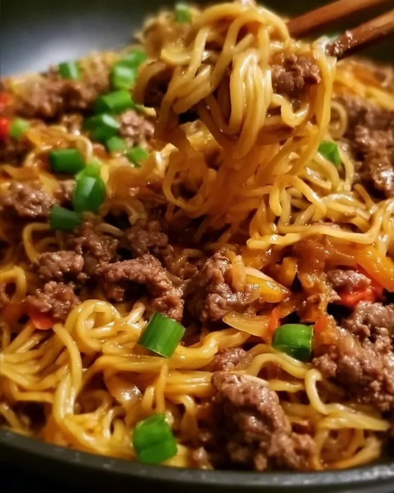Plate of Mongolian Ground Beef Noodles garnished with green onions.