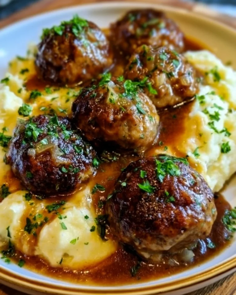 Salisbury steak meatballs served with garlic herb mashed potatoes